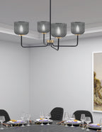 Sandia Four Light Chandelier in Matte Black & New Age Brass with Smoke Textured Shade